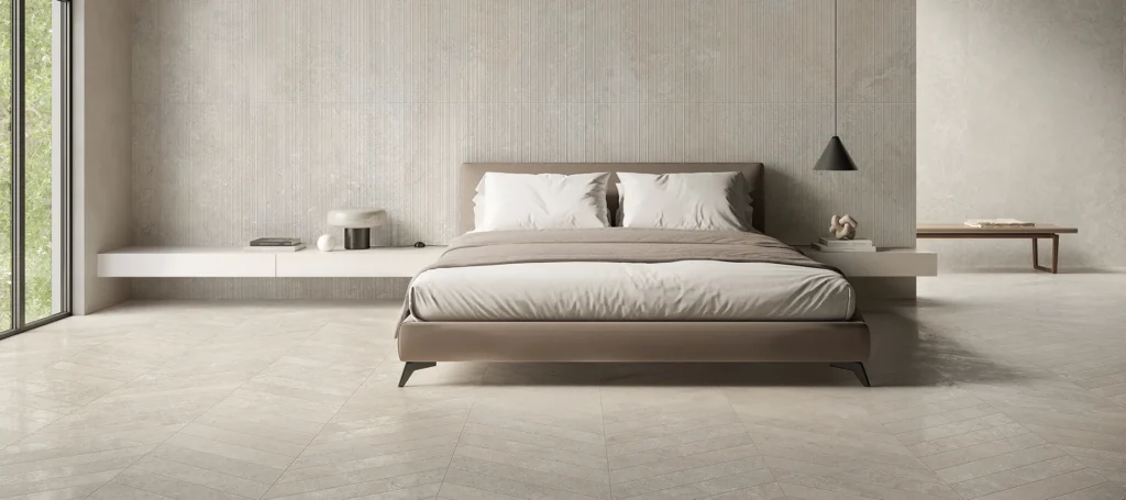 Modern bedroom with limestone walls and flooring, featuring a minimalist design with neutral tones and natural light.