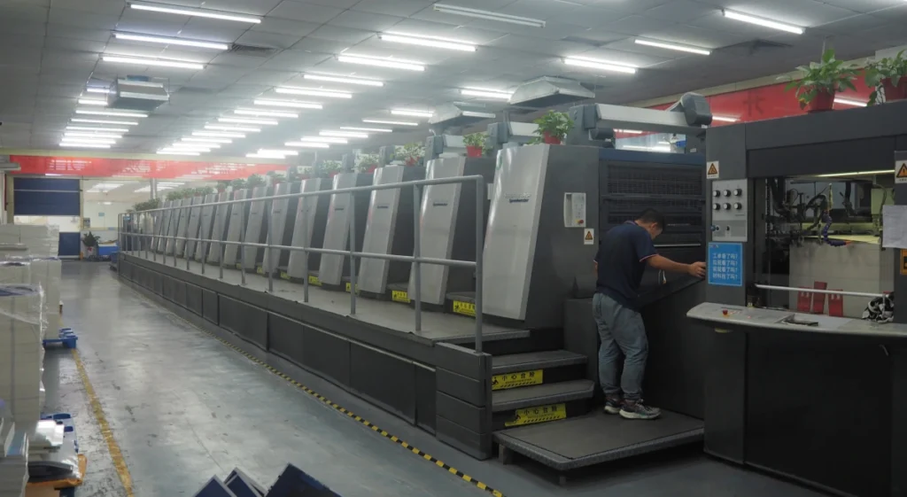 High-tech printing machine with a worker operating in a modern packaging production facility.